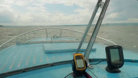 View of cloudy sky and wavy river from boat which moves forward. Navigator is on Stock Footage 144303999