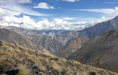 View of the cloudy sky landscape over the Asian mountains on an autumn day. Stock Photos