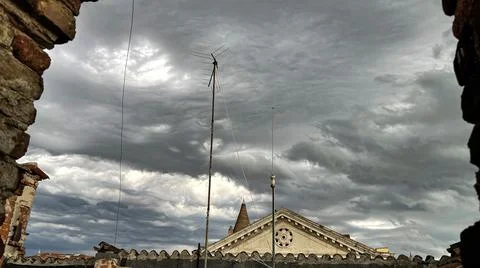 View of the cloudy sky from the rooftops of Venice. Stock Photos