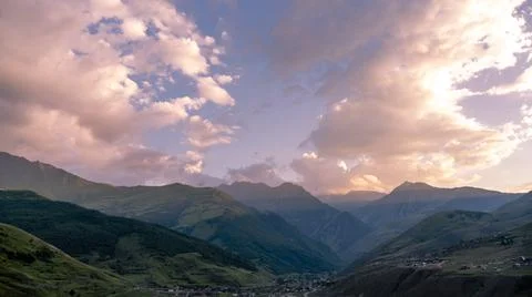 View of the cloudy sky at sunset in Fiagdon, North Ossetia, Russia. Impenetra Stock Photos