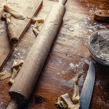 View of a cluttered kitchen table after making handmade dough. Stock Photos