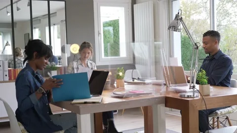 View of co-workers in open space office protected by plexiglas Video stock 146055666