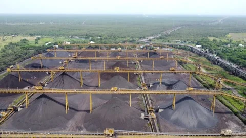 View of the coal terminal air with coal transport trucks and coal conveyor .. Stock Footage 293116320