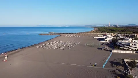 View of coast and big sand beach. Bathhouses and clear horizon Stock Footage 137863933