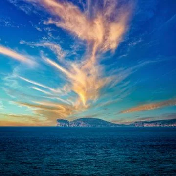 View of the coast of capo caccia with dramatic csky at sunset Stock Photos