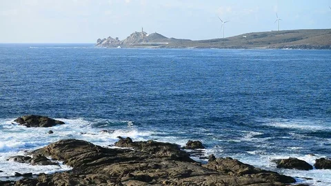 View on the coast of the ocean and Cape Vilan Lighthouse in the background, Muxi Stock Footage 79951180