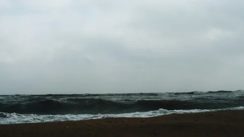 View from the coast to the srtong waves in cloudy weather Stock Footage 107987988