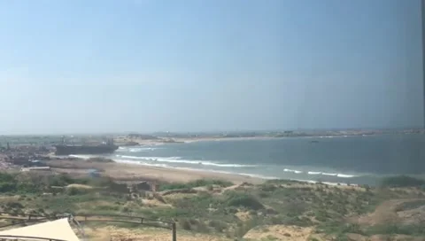 View of a coastal landscape with a beach and ocean seen through a window Stock Footage 317599001