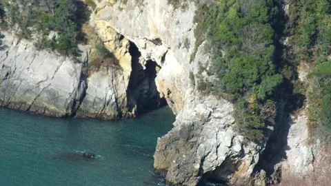 The view of the coastline and cave Stock Photos