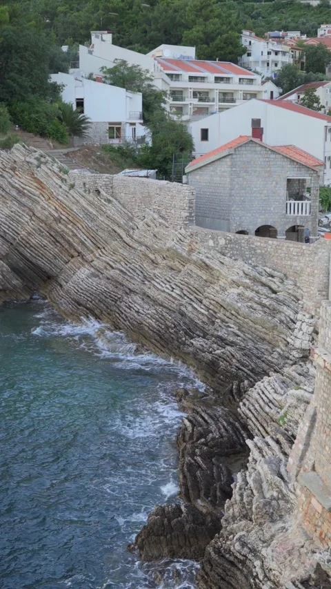 View of coastline, sea, cliffs, old city buildings and restaurant Stock Footage 280512370