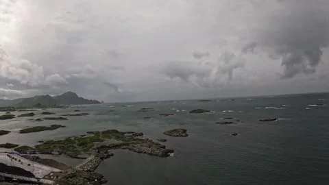 View of coastline, small islands, and stormy ocean clouds in Andenes Norway Stock-Footage 342755590
