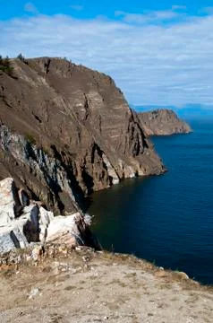 View of coastline with steep bare cliffs and headland Stock Photos