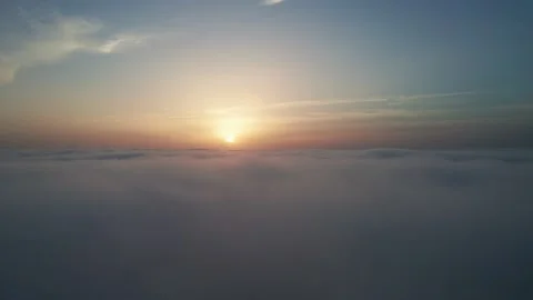 View from the cockpit of an airplane above the clouds at sunrise. Video stock 223352934