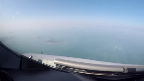 View from Cockpit during flight while overflying islands Stock Footage 248036320