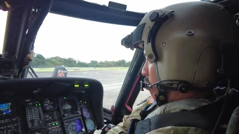 View from cockpit U.S. Army UH-60 Blackhawk pilot preparing for take-off Stock Footage 260385860