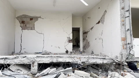 View of the collapsed wall room of a collapsed and cracked house, earthquake Stock Footage 243121545