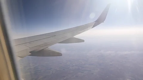 View from a commercial Delta airline window seat containing a wing of the Stock Footage 128767598