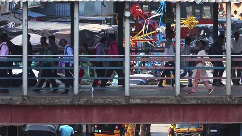 View of commuters walking at crowded Bandra railway skywalk. Rush hour time. Stock Footage 274499246