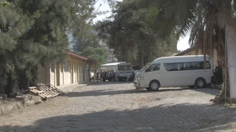 View of a compound of a work place where a group of people is seen chilling out Stock Footage 108477141