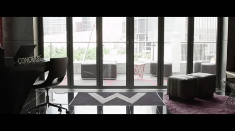 View from concierge desk of nice lounge out patio window Vidéo 57125012