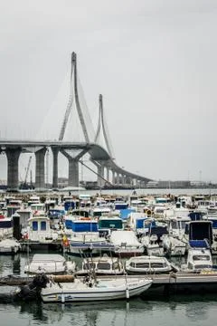 View of the constitution bridge in cadiz with small boats underneath Stock Photos