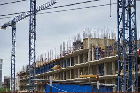 A view of a construction crane operating on large construction sites, and many Stock Photos