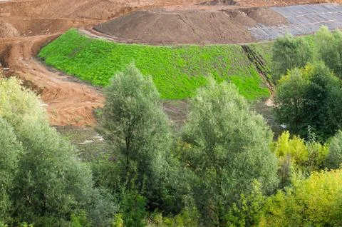 View to  the construction of the road type. The high mounds of .ground, stones Stock Photos
