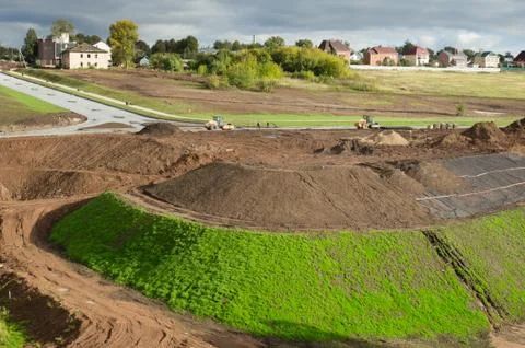 View to  the construction of the road type. The high mounds of .ground, stones Stock Photos