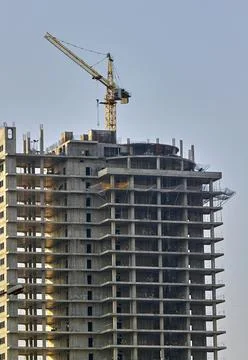 View of a construction site and a working crane working in a new construction Stock Photos