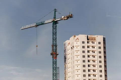 View of the construction site with crane and high-rise residential building Stock Photos