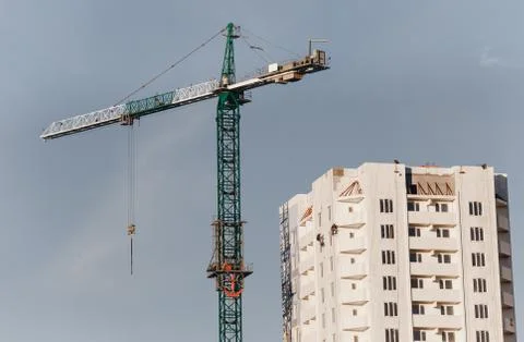 View of the construction site with crane and high-rise residential building Stock Photos