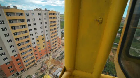 View of the construction site with high crane. Crane moves axially Stock Footage 24309498