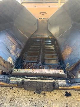 View of a construction vehicle showing the inside of the dump bed where asp.. Stock Photos