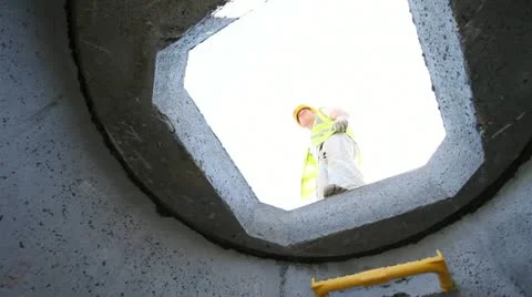 View of construction worker from drainage pipe. Stock-Footage 11024307
