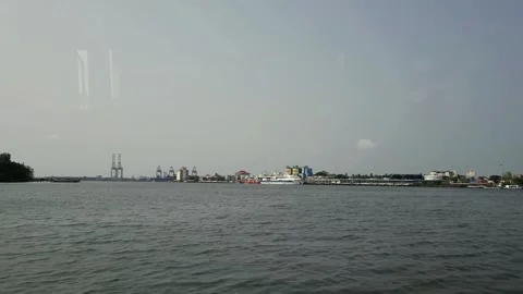 View of container terminal and harbor docks seen from the water across a tropica Stock-Footage 341514541
