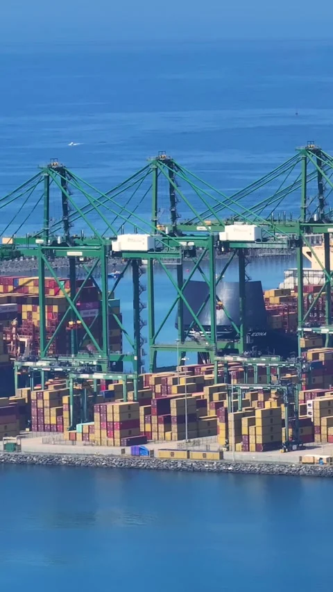 View of container terminal with shipping containers and cargo ship activity Stock Footage 340235213