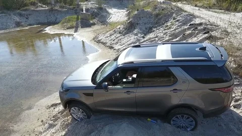 View of contemporary car parked in front of puddle. Video stock 80979122