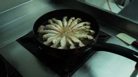 View of cooking frying capelin fish in iron pan Stock Footage 145240239