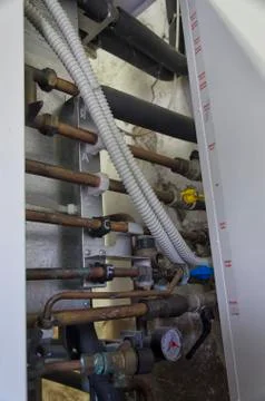 View of copper tubes and knobs inside a boiler Foto stock