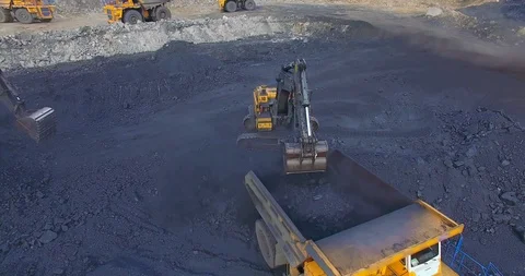 View from copter excavator loads coal into dump truck Stockbeeldmateriaal 122076229