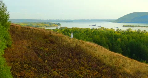 View from a copter, vastness of nature, forest and hills. Woman in a dress is Video stock 144639712