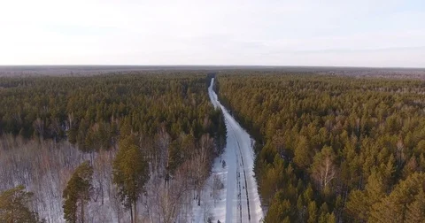 View from copter on winter coniferous forest and a country road Stock Footage 74744007