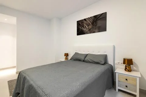 View from the corner of the double bed and bedside table with stylish gray Stock Photos