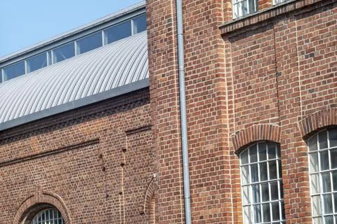 View of a corner window on an industrial brick building with metal elements, Fotos Stock