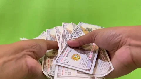 A view of counting dollar bills on a green background. Stock Footage 326144298
