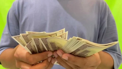 A view of counting dollar bills on a green background. Stock Footage 326144321