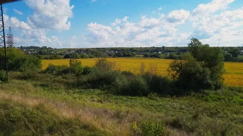 View to the countryside fields from open window of quickly driving train. Stock Footage 161391990