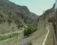 View of countryside from moving train and entering tunnel SD Footage