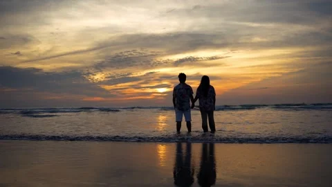 View of a couple holding hands on the beach at sunset, Bangladesh. Stock Footage 335022647