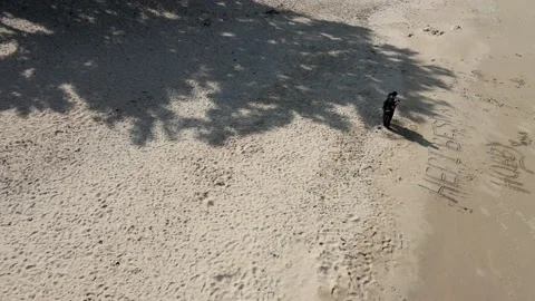 View of Couple standing in front of a beach in Johor Stock Footage 148012415